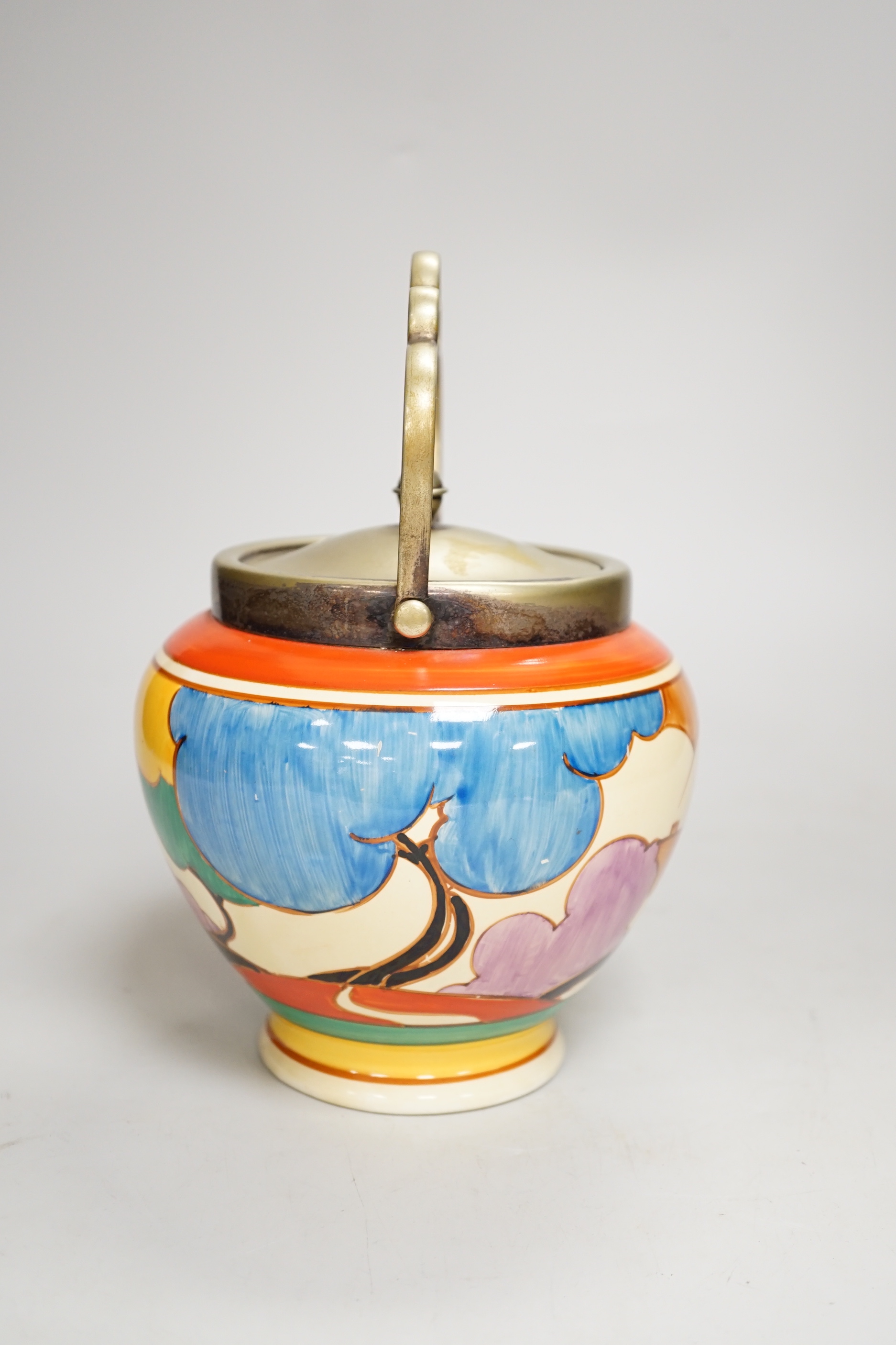 A Clarice Cliff biscuit jar, Blue Autumn, c.1931 with silver plated lid and swing handle, 21cm high